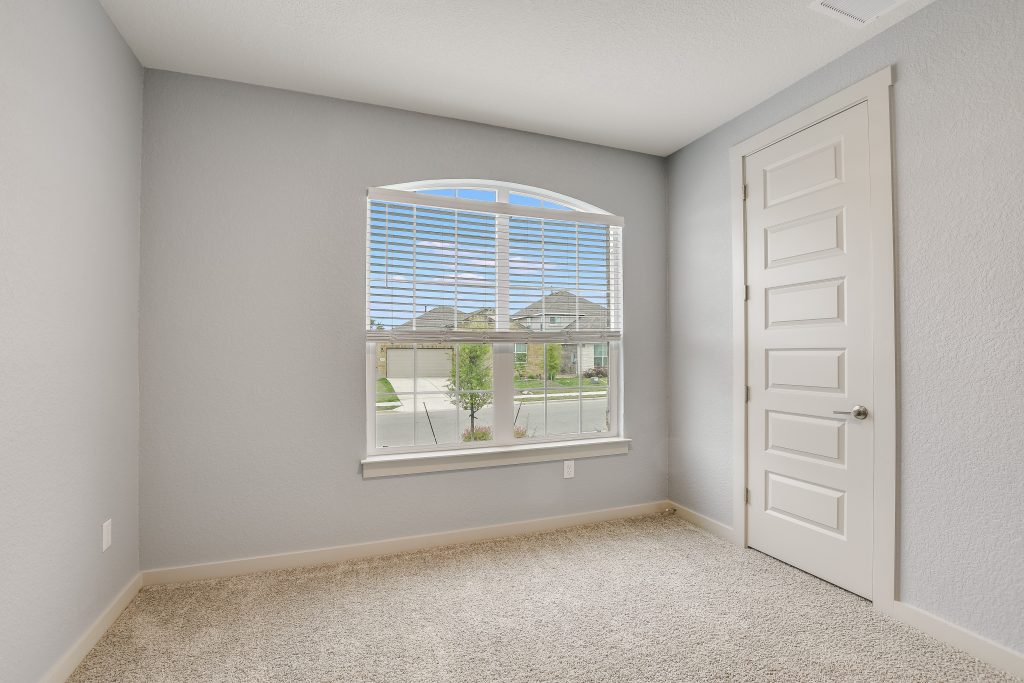 Bedroom 2 at the front of the home with a good size closet.